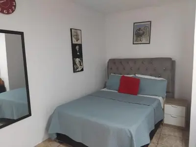 a bedroom with a bed with blue and red pillows at Blessing secure unit in Pretoria