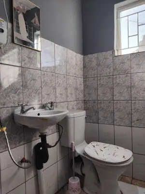 a bathroom with a toilet and a sink at Blessing secure unit in Pretoria