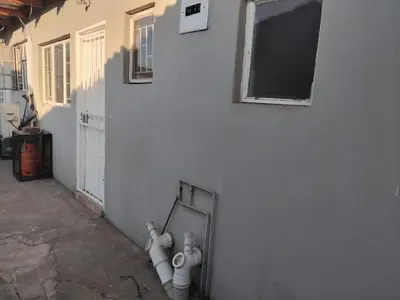 two white fire hydrants are leaning against a wall at Blessing secure unit in Pretoria