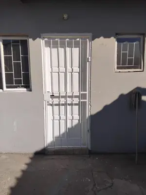 a door with a metal gate on the side of a building at Blessing secure unit in Pretoria