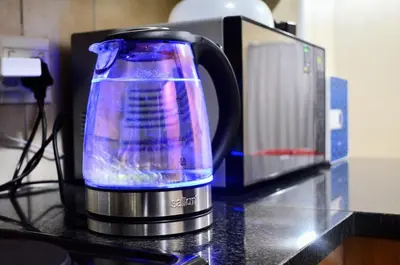 a coffee pot sitting on a counter next to a microwave at Welcome Home in Midrand