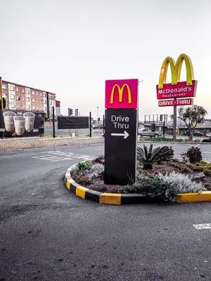a mcdonalds drive thru sign in the middle of a street at Welcome Home in Midrand