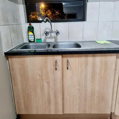 a kitchen counter with a sink and a window at Welcome Home in Midrand