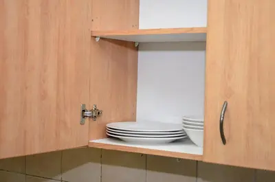 a cupboard with plates and bowls in it at Oasis Home in Midrand