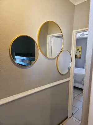 three mirrors on a wall in a room at Bela Bela Pendleberry Grove 52 in Bela-Bela