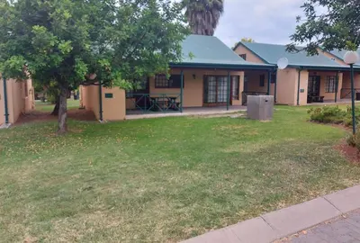 a house with a yard with a tree at Bela Bela Pendleberry Grove 52 in Bela-Bela