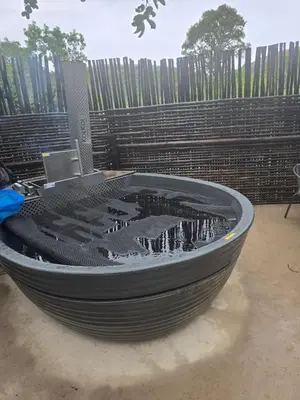 a large black tub sitting in front of a fence at Mbekka Lodge, Mabalingwe in Moheme