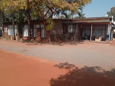 a building with a tree in front of it at Willmore Guesthouse and Accommodation in Mokopane