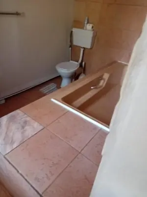 a bathroom with a toilet and a tub in a room at Willmore Guesthouse and Accommodation in Mokopane