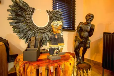 a statue of a man sitting on a table with a mirror at Wild Whispers in Marloth Park