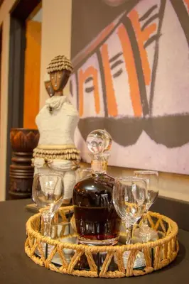 a tray with a bottle of wine and three wine glasses at Wild Whispers in Marloth Park