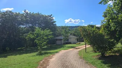 a dirt road in front of a house at Sand River Cottages in Hazyview