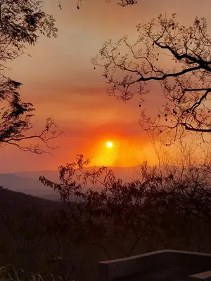 a sunset with the sun setting in the distance at Nguni Rest in Barberton