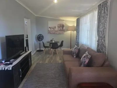 a living room with a couch and a table at Nguni Rest in Barberton