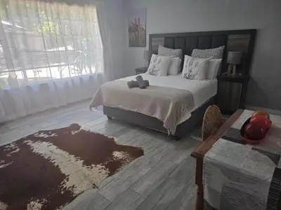 a bedroom with a bed with a teddy bear on it at Nguni Rest in Barberton