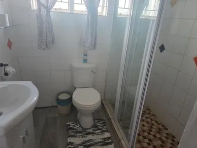 a bathroom with a toilet and a shower and a sink at Nguni Rest in Barberton