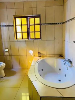 a bath tub in a bathroom with a window at Nteto guesthouse in Dwarsloop