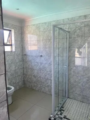 a bathroom with a shower and a toilet at 606 Guesthouse in Bushbuckridge
