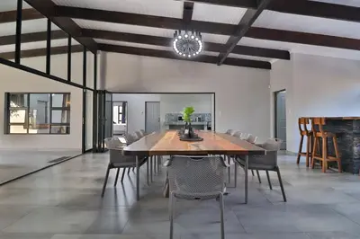 a dining room with a table and chairs at Kruger Stories at Marloth in Marloth Park