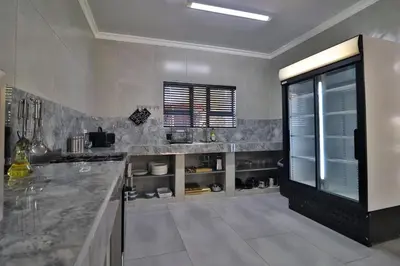 a kitchen with a marble counter and a window at Kruger Stories at Marloth in Marloth Park