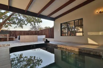 a swimming pool in the backyard of a house at Kruger Stories at Marloth in Marloth Park