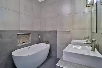 a bathroom with a white tub and a sink at Kruger Stories at Marloth in Marloth Park