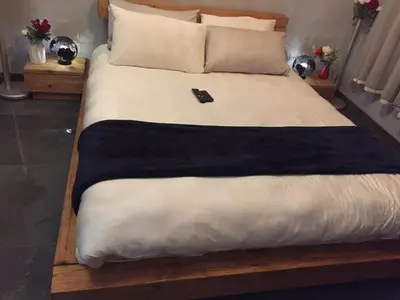 a bed with a black phone sitting on top of it at The Concept in Centurion