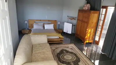 a bedroom with a bed and a couch in a room at The Concept in Centurion