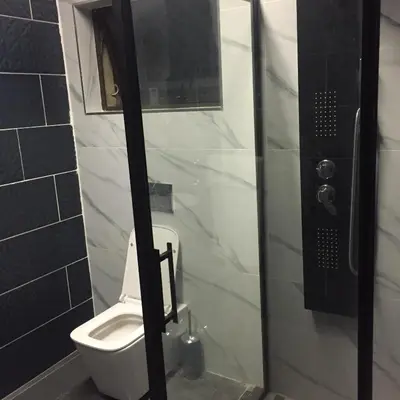 a bathroom with a toilet and a glass shower door at The Concept in Centurion