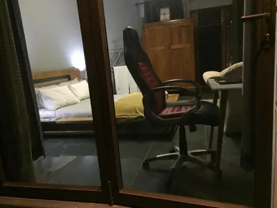 a chair sitting in a room with a bed at The Concept in Centurion