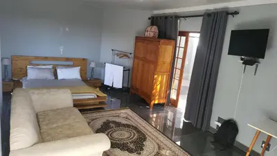 a living room with a couch and a bed at The Concept in Centurion