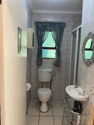 a bathroom with a toilet and a sink at Stay in Woodhill Golf Estate near Pretoria East Hospital in Pretoria