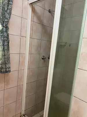 a shower with a glass door in a bathroom at Stay in Woodhill Golf Estate near Pretoria East Hospital in Pretoria