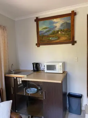 a kitchen with a counter with a microwave on it at Stay in Woodhill Golf Estate near Pretoria East Hospital in Pretoria