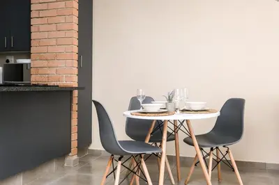a table with chairs and wine glasses on it at Mkhonto's waterfall ridge in Midrand