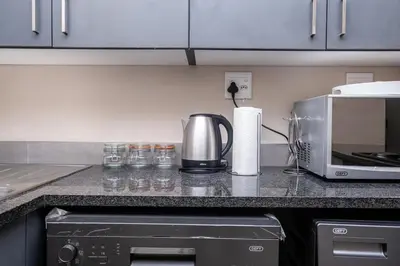 a kitchen counter with a coffee maker and a microwave at Mkhonto's waterfall ridge in Midrand