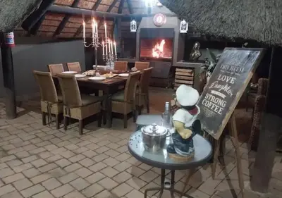 a kitchen with a table with a chef figurine sitting on a table in front at The Elephant Room at Frederick's Place in Pretoria