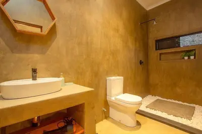 a bathroom with a sink and a toilet at Longneck Luxury Bush Lodge in Marloth Park