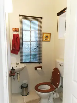 a bathroom with a toilet and a sink at Hardy-da Forest Cottage in White River