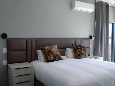 a bedroom with a large bed with white sheets and pillows at The Views at 492 Euphoria Golf Estate in Naboomspruit