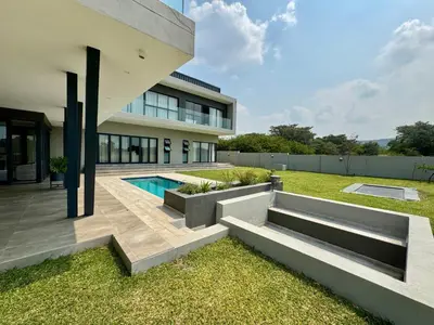 a backyard with a swimming pool and a house at The Views at 492 Euphoria Golf Estate in Naboomspruit