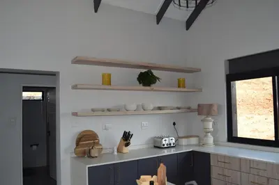 a kitchen with white walls and a counter top at Hururu House in Dullstroom