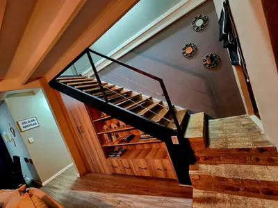 a staircase leading up to a room with wine bottles at Fairstreams Nr3 in Dullstroom