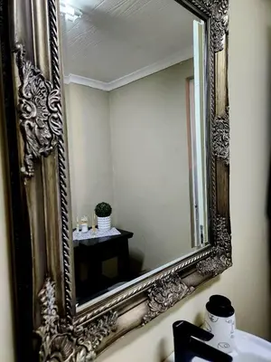 a mirror over a sink in a bathroom at Fairstreams Nr3 in Dullstroom