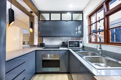 a kitchen with a sink and a microwave at ILanga Air B&B in Nelspruit