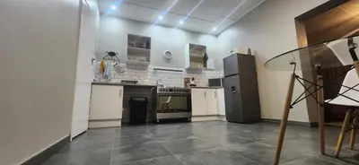 a kitchen with a stove and a refrigerator at Lazél Apartments in Ermelo