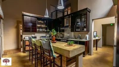 a kitchen with a table and some chairs in it at Zebula Golf and Wildlife Estate - Africa Breathing Pax 8 - Moi Signature Exclusive Villa in Mabula