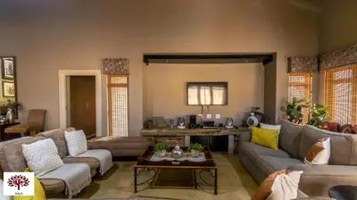 a living room with couches and a table at Zebula Golf and Wildlife Estate - Africa Breathing Pax 8 - Moi Signature Exclusive Villa in Mabula