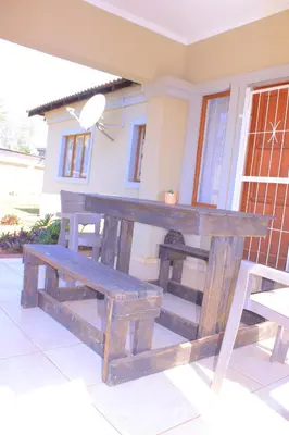 a wooden picnic table and bench on a patio at Vutomi Guesthouse in Burgersfort