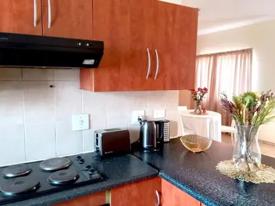 a kitchen with a counter top with a stove top oven at Vutomi Guesthouse in Burgersfort